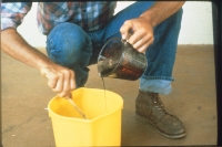 The inoculant-sticker mixture is poured onto seed.