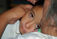 girl comforted by grandparent