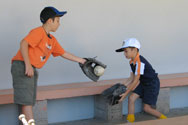 two boys play baseball