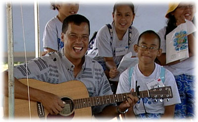 Jon Osorio teaching with music at Palama Settlement Keiki Water Festival