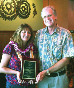 Tanya Ashimine of Kaiser High School receiving the national President’s Prize for Outstanding Achievement with CTAHR’s Ken Grace.