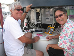 Charles Nelson and Dr. Hara doing an equipment check before flipping the switch to another chamber full of Christmas trees.