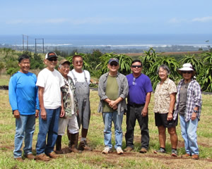 Faculty Volunteers are caught in a rare moment of inactivity, posed in front of the experimental dragon fruit plot.